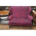 A CHIPPENDALE DESIGN MAHOGANY AND UPHOLSTERED TWO SEATER WING BACK SETTEE,