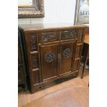 AN ORIENTAL HARDWOOD AND CARVED SIDE CABINET,