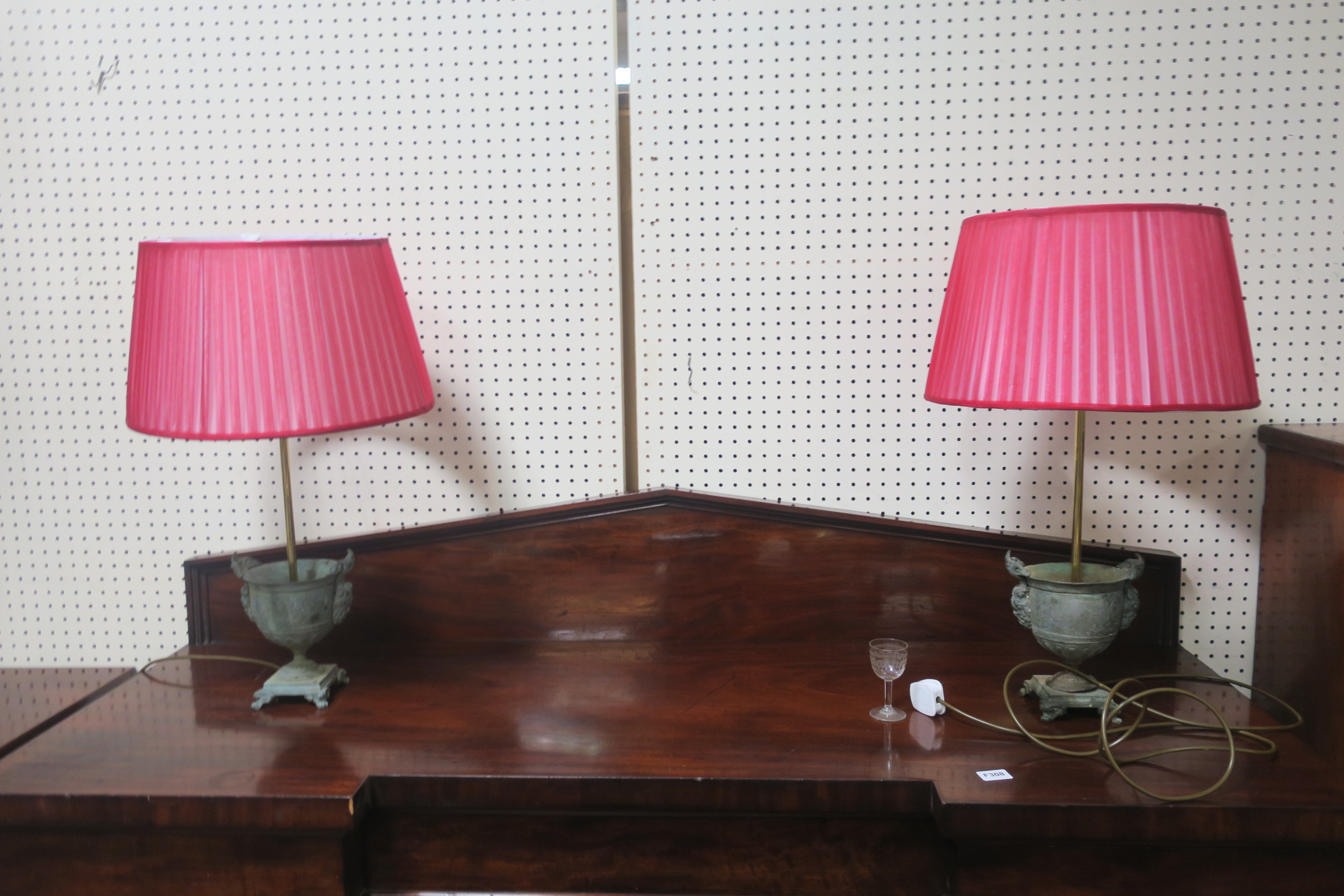 A PAIR OF HEAVY BRONZE TABLE LAMPS each of urn form cast with figural masks above rectangular base