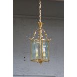 A BRASS AND GLAZED FOUR LIGHT HALL LANTERN,