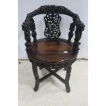 A VERY FINE ORIENTAL CARVED TUB SHAPED SWIVEL CHAIR,