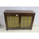 A 19TH CENTURY MAHOGANY SIDE CABINET the rectangular shaped top above a pair of brass grilled doors