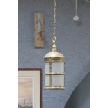 A BRASS AND FROSTED GLASS SINGLE LIGHT HALL LANTERN of cylindrical form