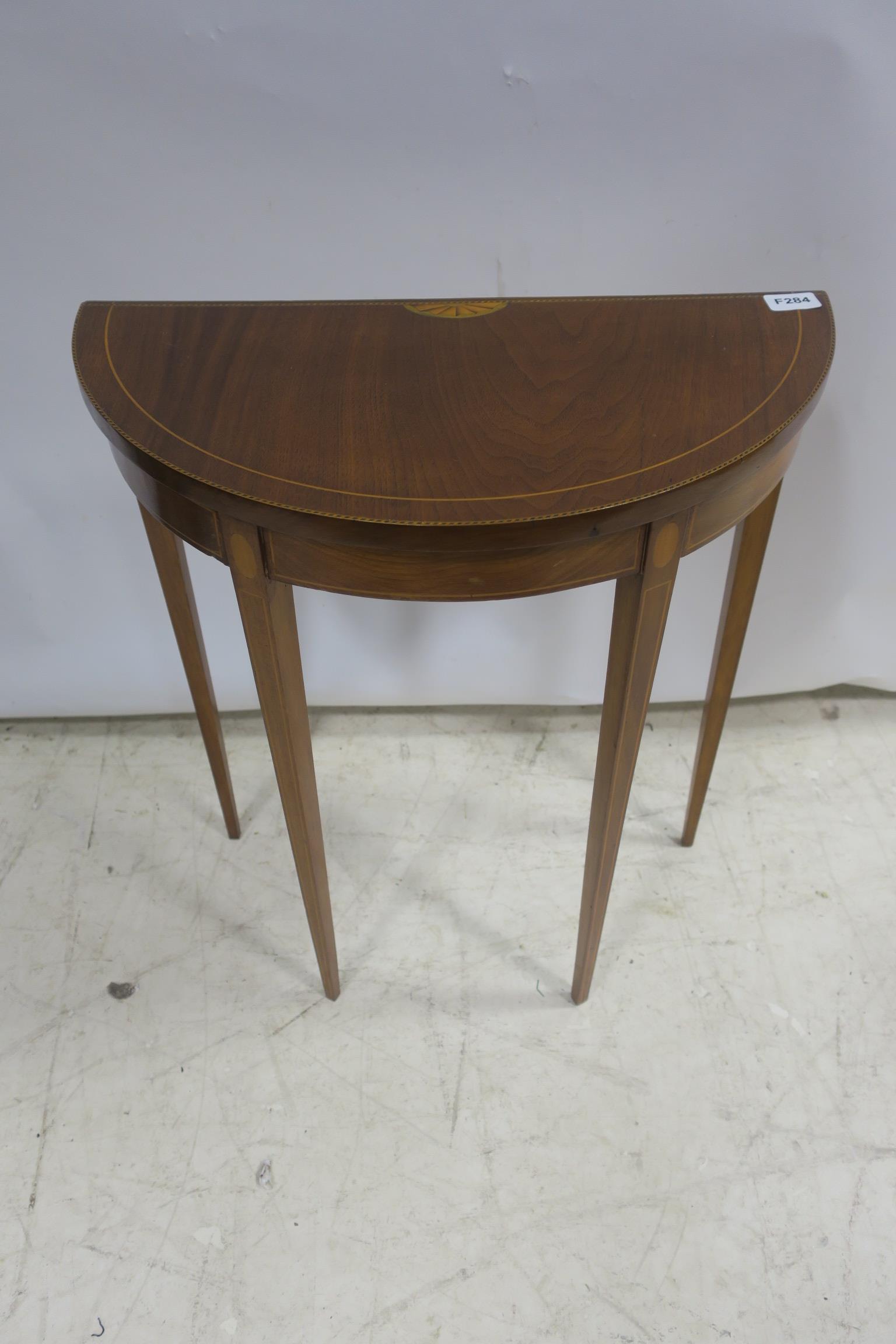 A SHERATON DESIGN MAHOGANY INLAID SIDE TABLE of demi lune outline the shaped top raised and square