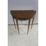 A SHERATON DESIGN MAHOGANY INLAID SIDE TABLE of demi lune outline the shaped top raised and square