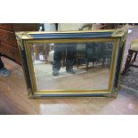 A CONTINENTAL GILT FRAME AND EBONISED MIRROR,