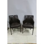 A PAIR OF RETRO MAHOGANY AND HIDE UPHOLSTERED TUB CHAIRS each with a shaped back and upholstered