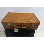 A RETRO LEATHER SUITCASE, bears label 'H.R.H.