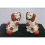 A PAIR OF STAFFORDSHIRE DESIGNED FIGURES each modelled as a dog shown seated 30cm (h)