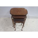 A NEST OF THREE WALNUT TABLES each with a shaped moulded top raised on cabriole legs the larger