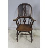 A 19TH CENTURY ELM WOOD WINDSOR CHAIR the curved top rail above a pierced vertical splat with