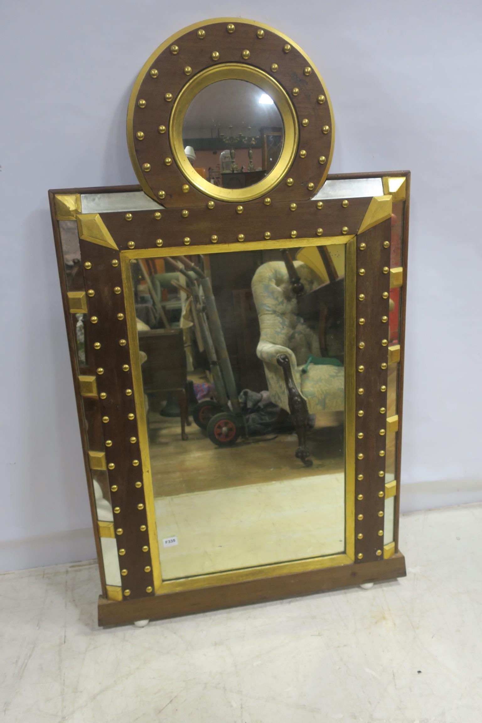 A CONTINENTAL MAHOGANY AND PARCEL GILT MIRROR the rectangular plate within a moulded frame with