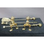 A SET OF THREE BRASS FIRE IRONS, with claw and ball handle,