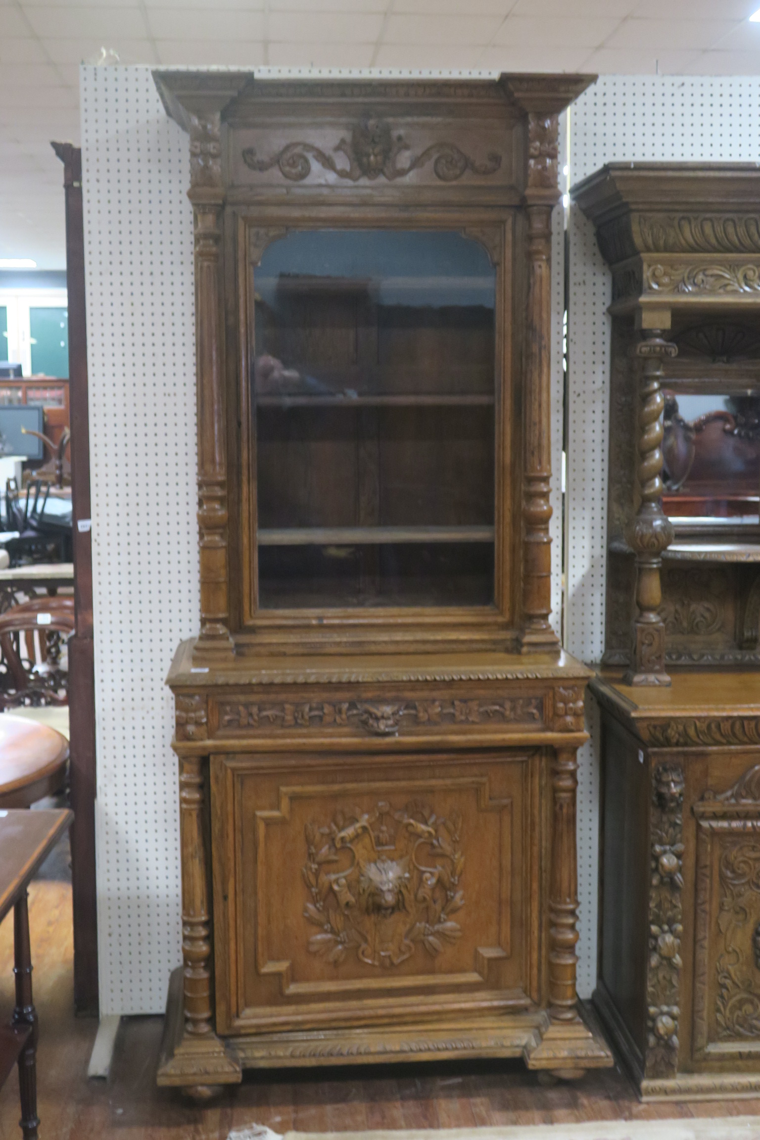 A FINE PAIR OF 19TH CENTURY CARVED OAK BOOKCASES each of inverted breakfront outline the frieze