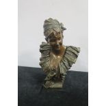 A CAST BRONZE BUST OF A FEMALE with ribbon tied hair band and linen drapery on a shaped base 47cm