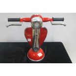 A WHITE METAL AND POLYCHROME TABLE LAMP in the form of a part vespa scooter 39cm (h) x 42cm (w)