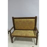 A BEECHWOOD AND UPHOLSTERED SETTEE the rectangular upholstered back and seat with moulded arms on