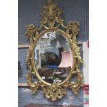 A CONTINENTAL GILTWOOD AND GESSO MIRROR,