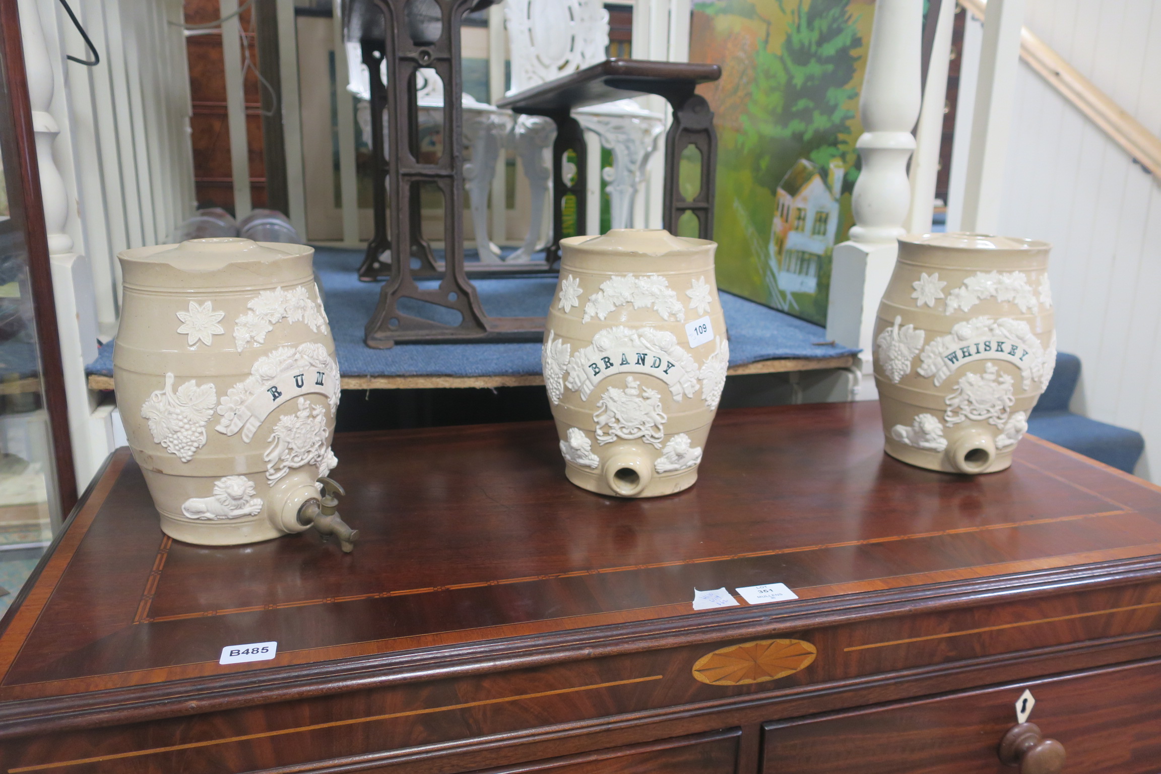 A SET OF THREE 19th CENTURY SPIRIT BARRELS, each of ovoid form moulded in relief with foliage,