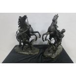 AFTER COUSTOU A FINE PAIR OF CAST BRONZE MARLEY HORSES WITH HANDLERS each shown rearing on astragal