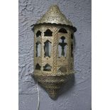 A BURMESE SILVER PLATE AND COPPER WALL LIGHT of demi lune outline embossed with stylized foliage