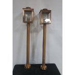 A SET OF FOUR COPPER COUNTER LANTERNS each with rectangular glazed hood above a cylindrical column