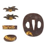 A set of six Japanese sword mounts, including an iron tsuba with gilt bat in relief.