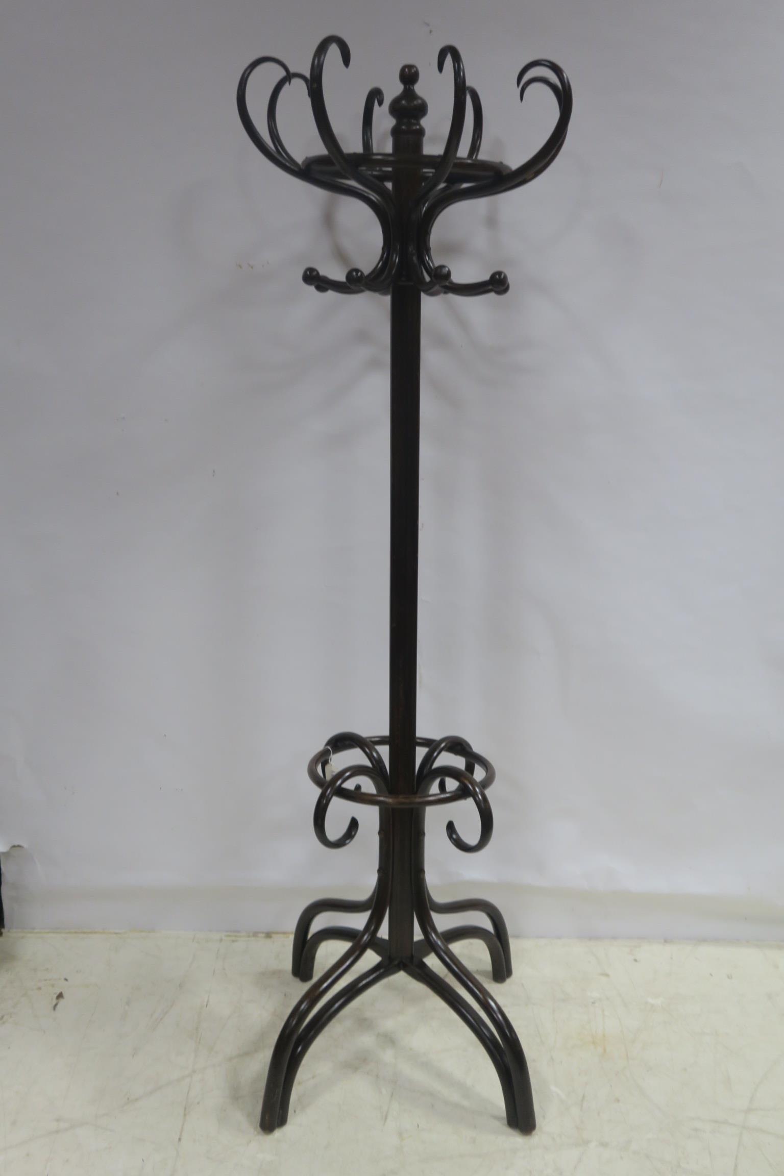 A BENTWOOD HAT COAT AND STICK STAND with revolving top above a moulded column on splayed legs