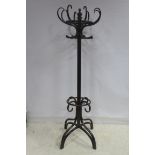 A BENTWOOD HAT COAT AND STICK STAND with revolving top above a moulded column on splayed legs