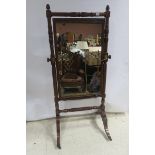 A VERY FINE REGENCY MAHOGANY CHEVAL MIRROR the rectangular plate within a spiral twist and leaf
