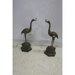 A PAIR OF CHINESE BRONZED FIGURES each modelled as a bird shown standing with head raised on a