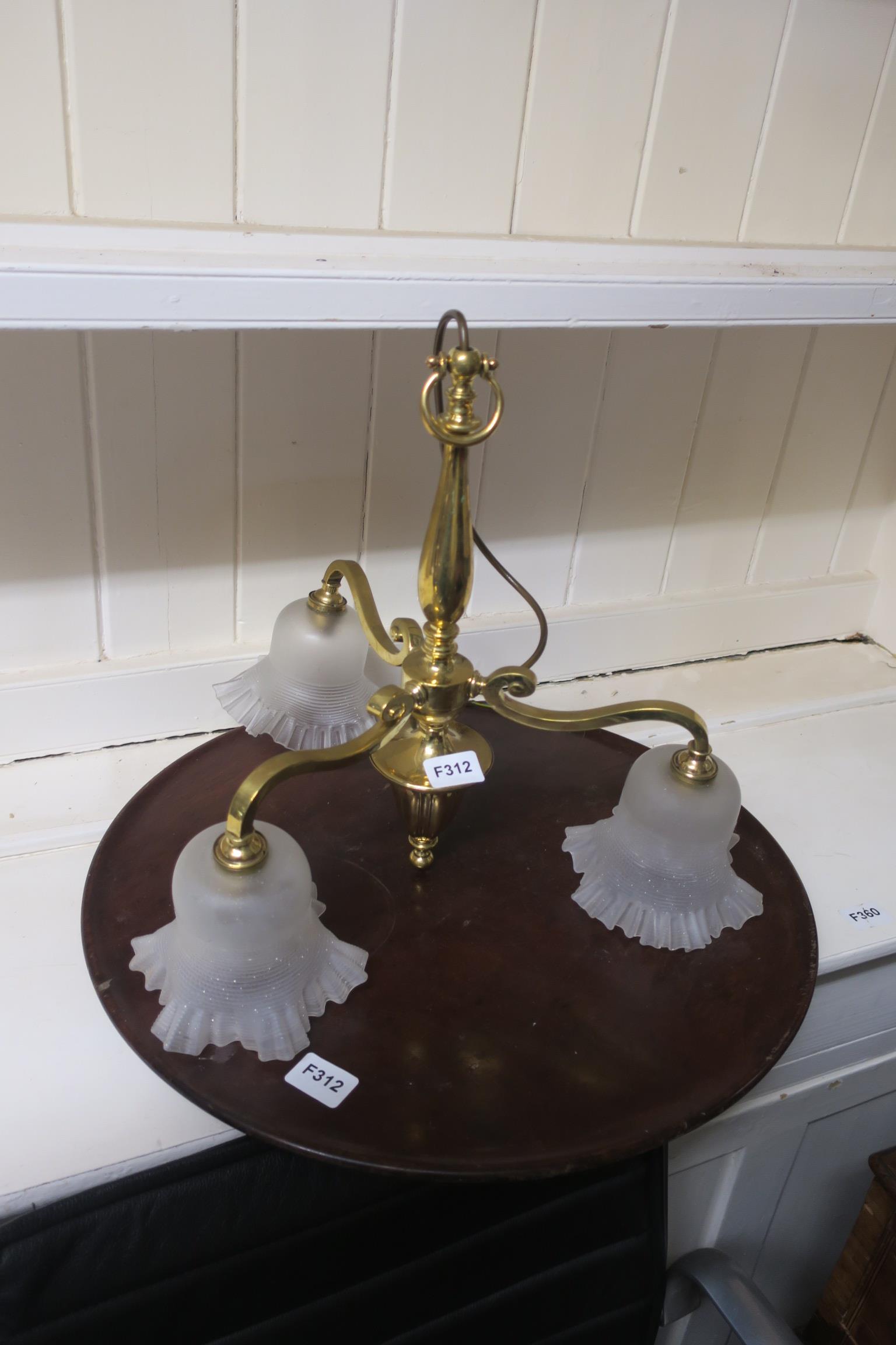 A BRASS THREE BRANCH CENTRE LIGHT with frosted glass shade together with a mahogany tray of