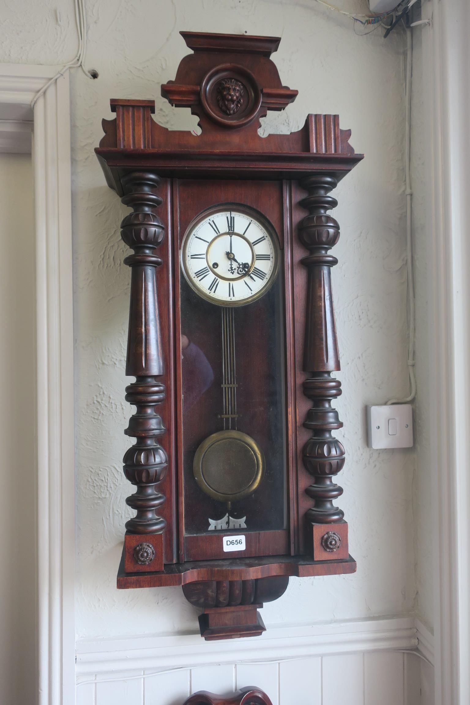 A 19TH CENTURY MAHOGANY CASE VIENNA CLOCK with figural mask cresting above the rectangular arched