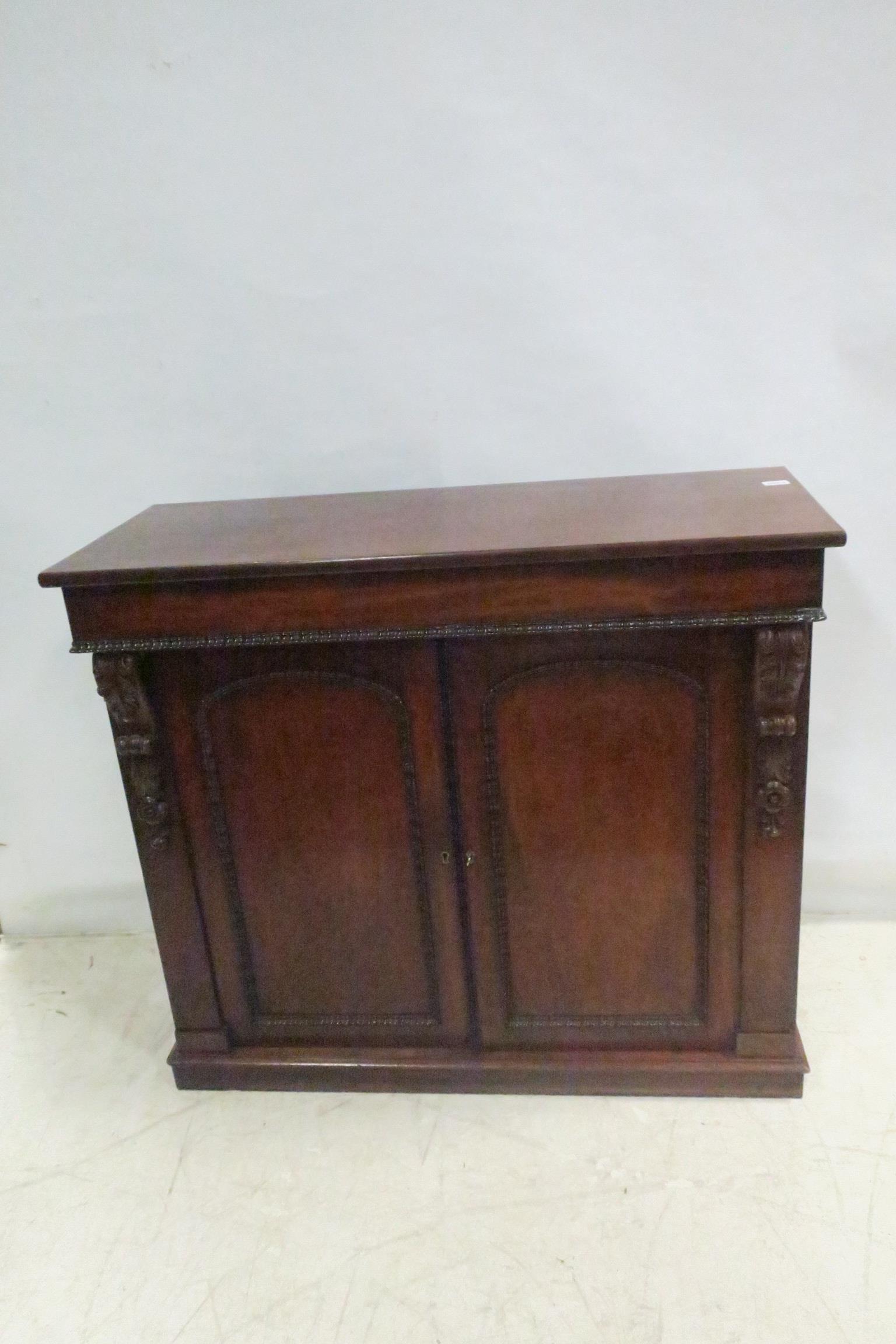 A FINE WILLIAM IV MAHOGANY SIDE CABINET of rectangular outline the shaped top above a pair of