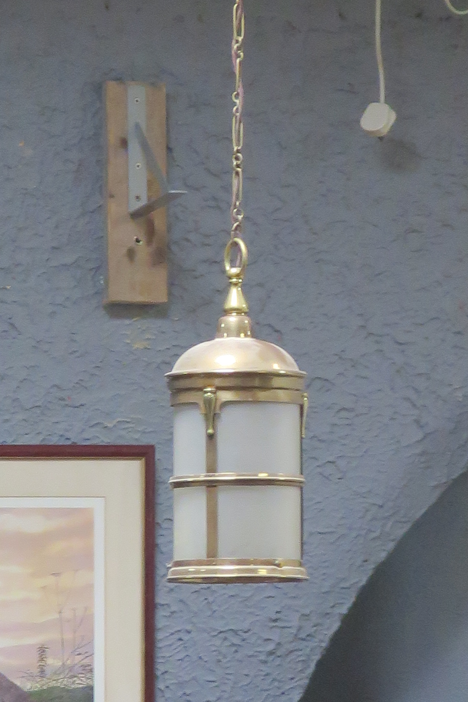 A BRASS AND FROSTED GLASS SINGLE LIGHT HALL LANTERN of cylindrical form