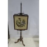 A 19TH CENTURY MAHOGANY POLE SCREEN the rectangular frame with C-scroll decoration containing