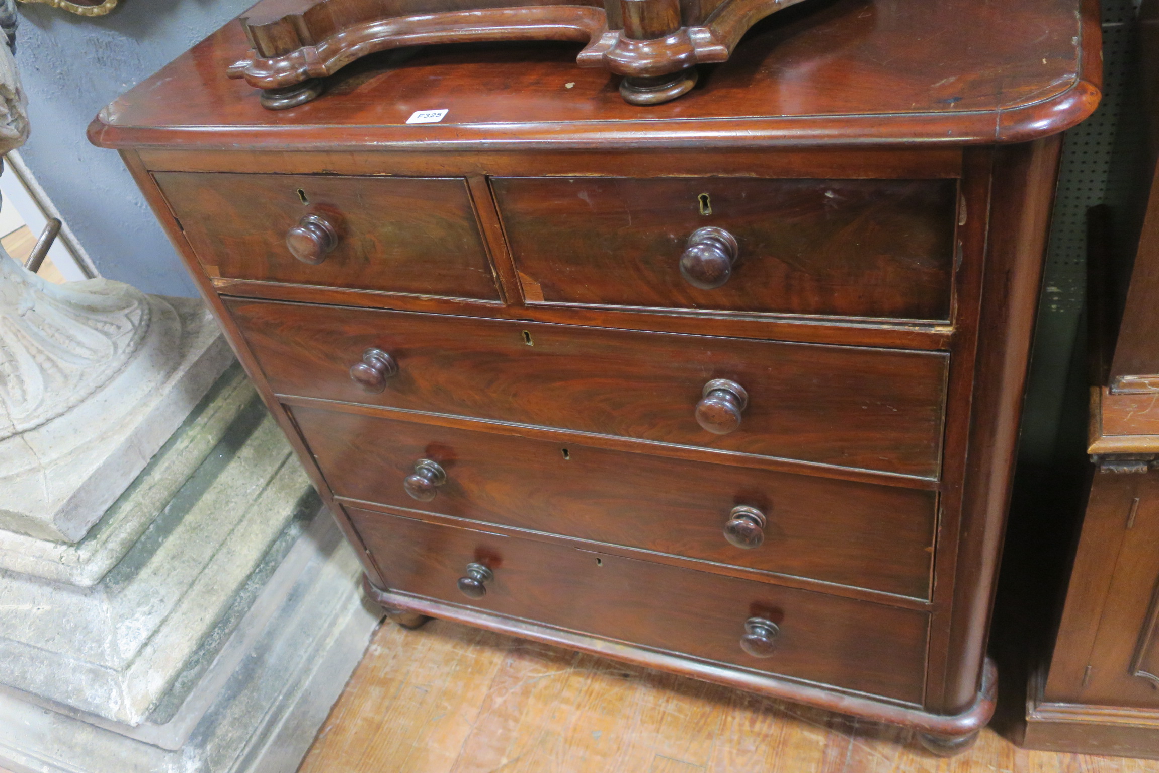 A 19TH CENTURY MAHOGANY CHEST the rectangular top above two short and three long drawers on bun
