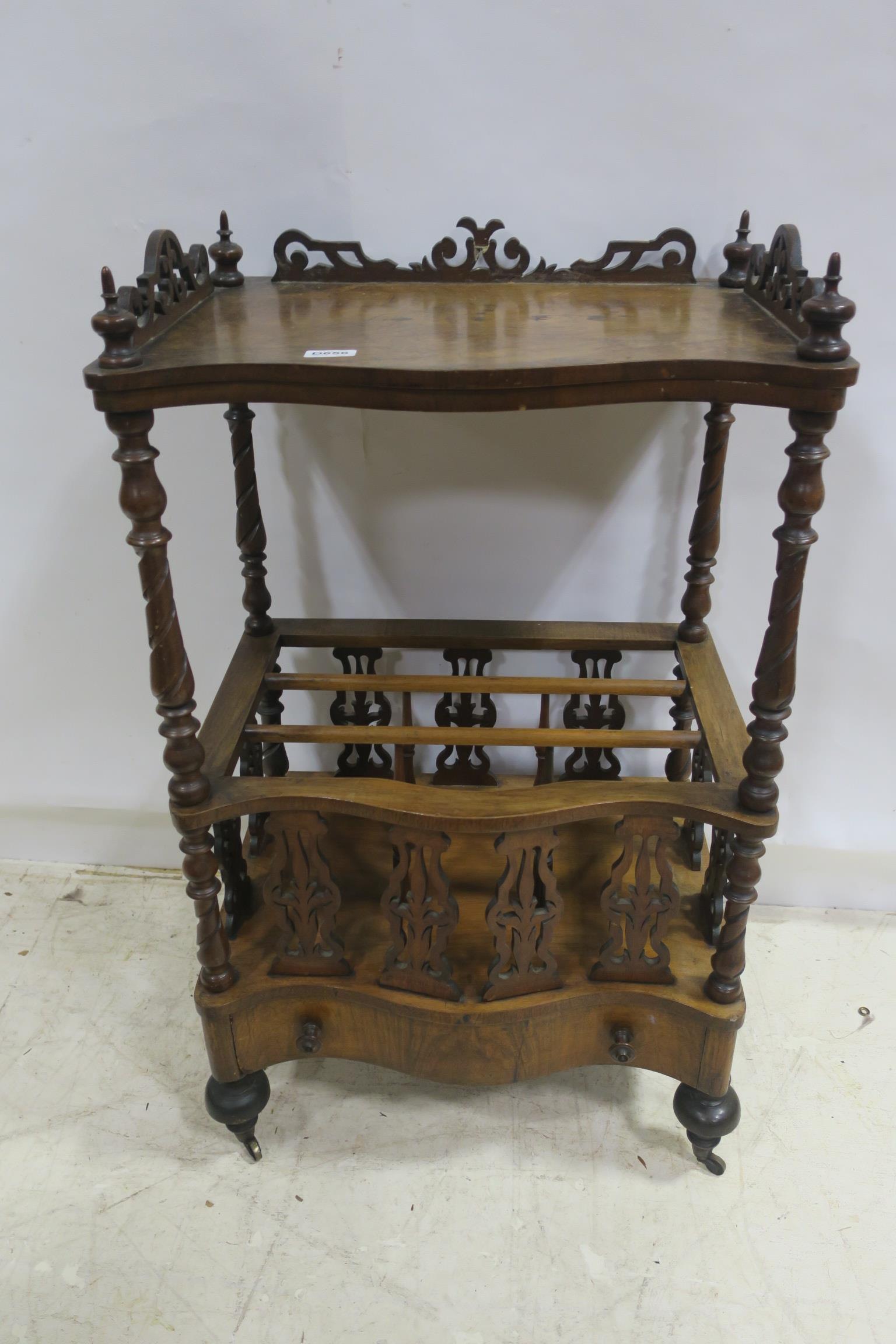 A 19TH CENTURY WALNUT CANTERBURY of serpentine outline the shaped top with pierced gallery and