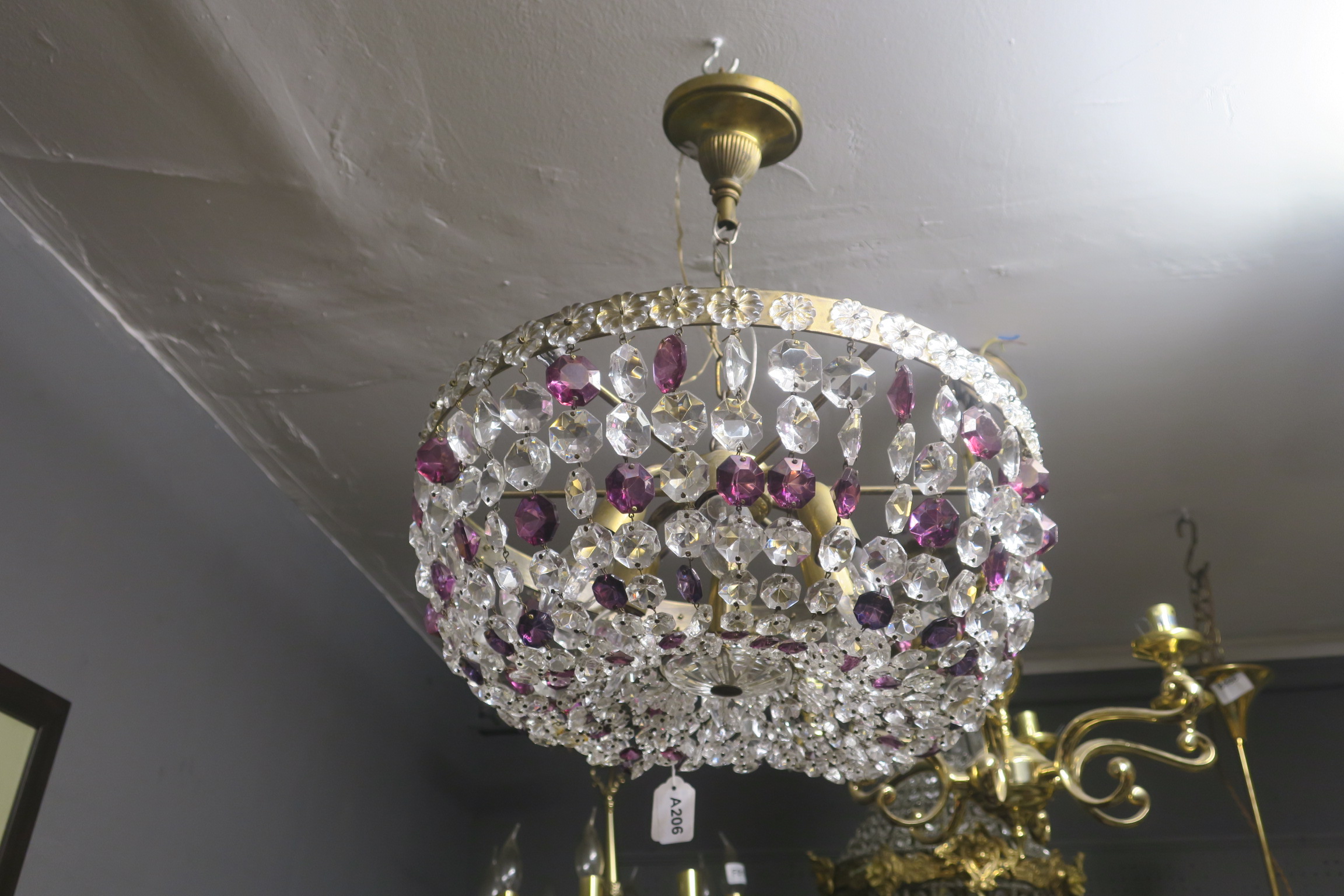 A CONTINENTAL GILT BRASS BASKET CENTRE LIGHT hung with ruby glass and clear glass facet pendants