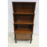 A SHERATON DESIGN MAHOGANY AND SATINWOOD INLAID FOUR TIER OPEN FRONT BOOKCASE with cupboard between