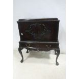 A CHIPPENDALE DESIGN MAHOGANY SIDE CABINET the rectangular top with cavetto frieze above a pair of
