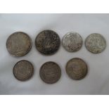 Seven silver coins: 1) 1921 US silver dollar 2) Chinese dollar 3) 1941 US half dollar 4) 1951 US