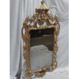 18thC carved gilt wood wall mirror with Chinese figure to top, C scroll, branch and leaf