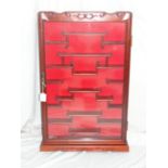 Pair of Chinese carved hardwood wall hanging cabinets with single glazed doors. Ht. 33 ins. width,