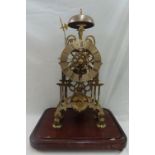 Victorian Gothic brass frame skeleton clock with silvered 4.75 ins. chapter ring, the single fusee