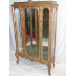 French carved gilt wood mirror-backed display cabinet with fruit and foliate decoration on