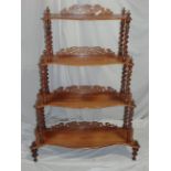 Victorian style serpentine fronted four tier what not with fretwork galleried backs, barley twist