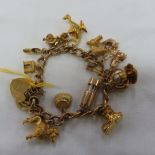 9ct gold charm bracelet with padlock and fifteen 9ct gold charms. 56g