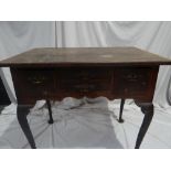 GII walnut cross banded low boy with four drawers, carved cabriole legs and pad feet. Width 35