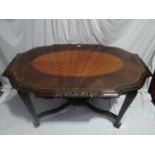 French kingwood and coromandel oval centre table with carved, shaped edge, carved legs and X